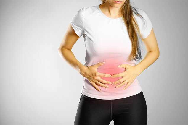 Mujer colocandose las manos sobre el estomago